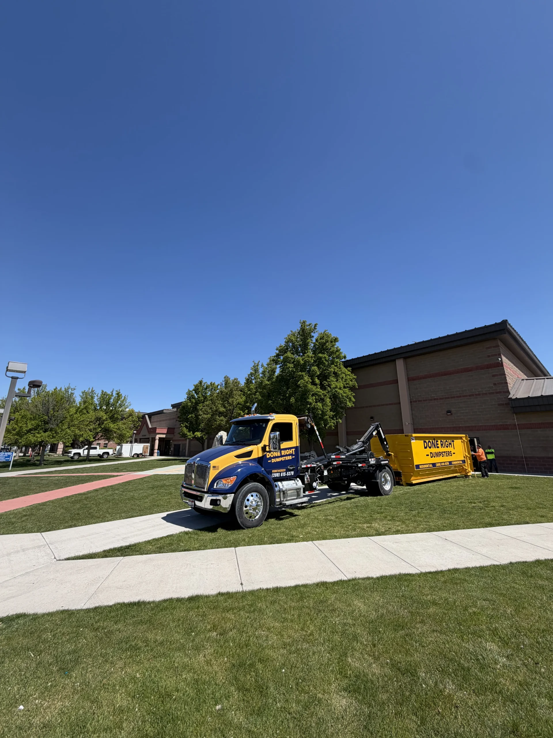Done Right Dumpsters dropping off a commercial dumpster at an Idaho job site