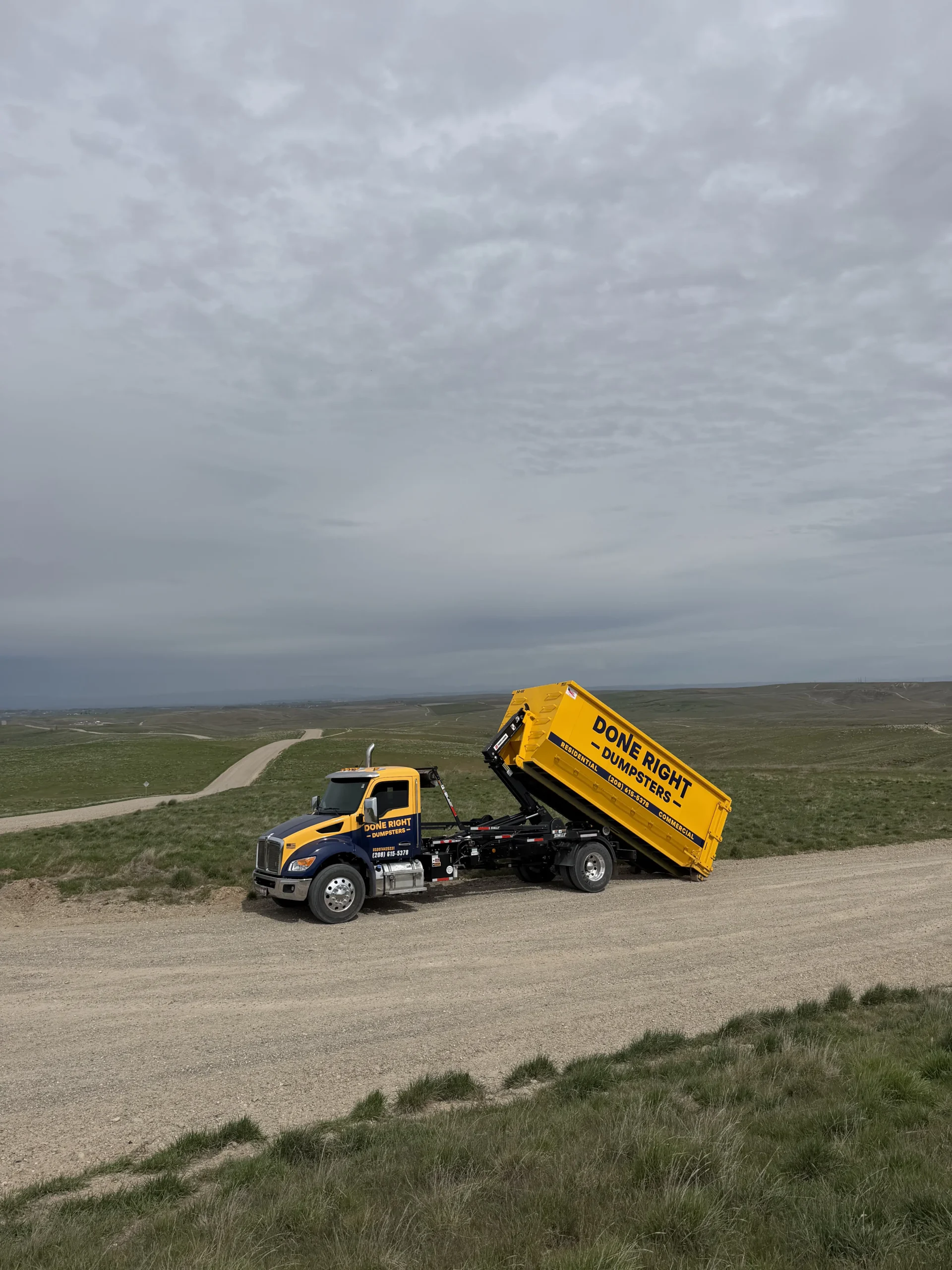 Done Right Dumpsters truck hauling a clean roll-off dumpster in the Treasure Valley